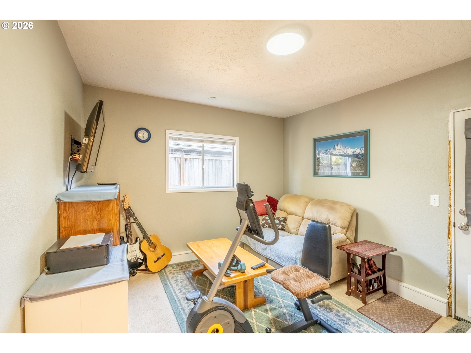 10480 Southwest Meadow Street Tigard, OR 97223 - Photo 8 of 20 a living room with furniture and a flat screen tv
