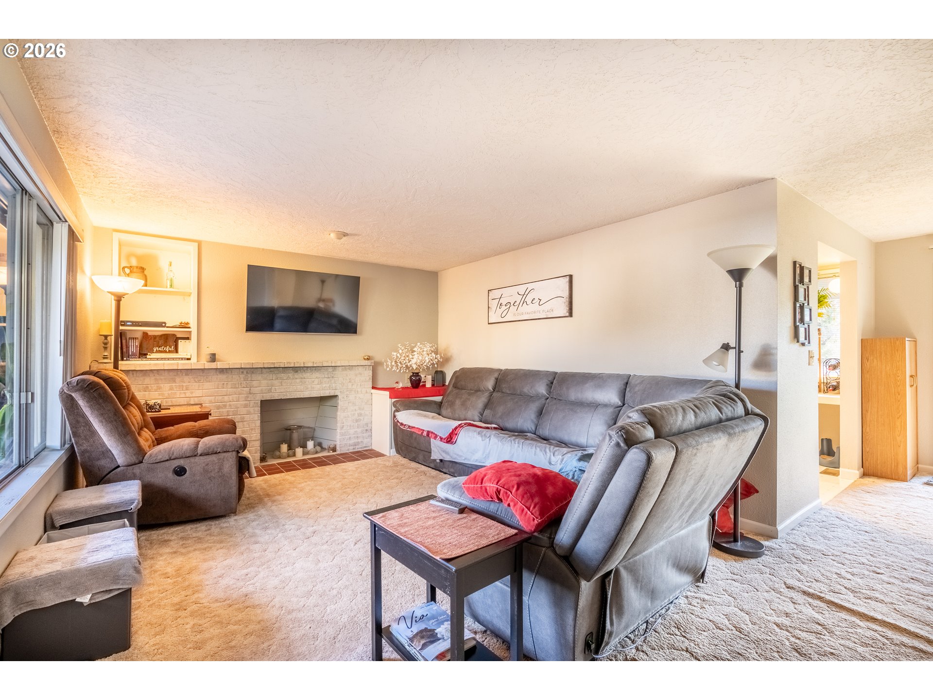 10480 Southwest Meadow Street Tigard, OR 97223 - Photo 9 of 20 a living room with furniture a fireplace and a flat screen tv