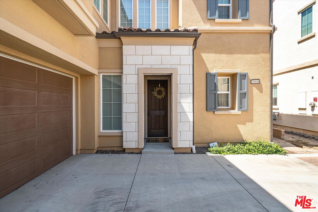 20646 West Chestnut Circle Porter Ranch, CA 91326 - Photo 3 of 44 a front view of a house with garage