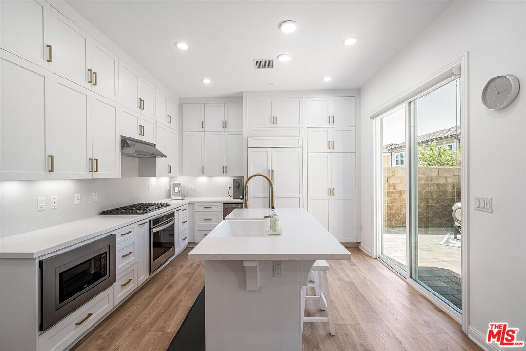 20646 West Chestnut Circle Porter Ranch, CA 91326 - Photo 8 of 44 a kitchen with a sink stainless steel appliances and cabinets