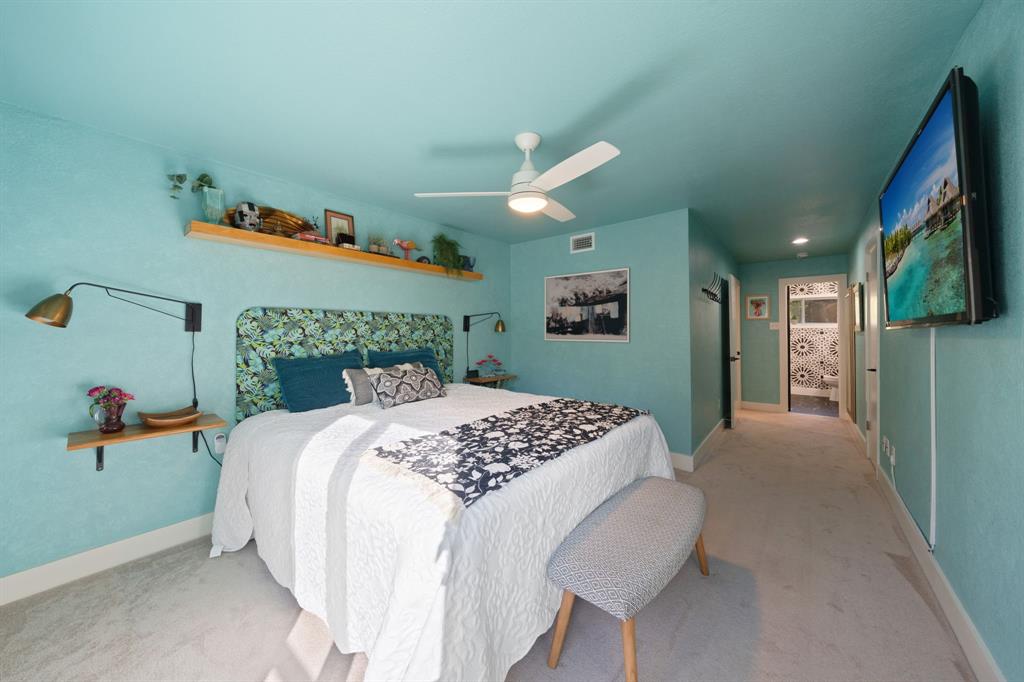 7496 East Northwest Highway, Unit 145 Dallas, TX 75231 - Photo 19 of 35 a bedroom with a bed and a painting on the wall