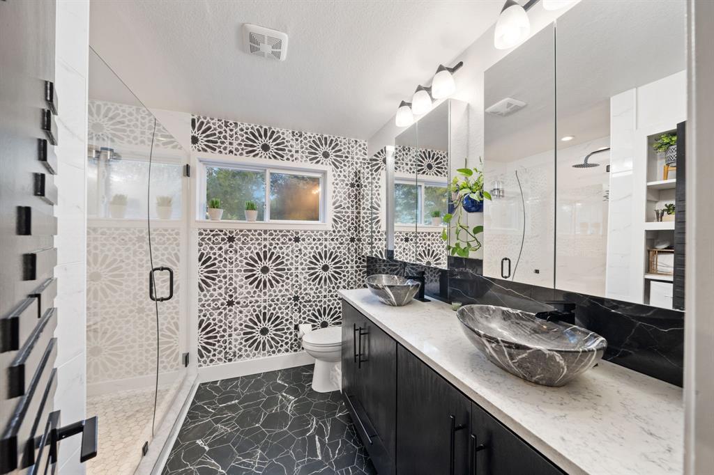 7496 East Northwest Highway, Unit 145 Dallas, TX 75231 - Photo 21 of 35 a bathroom with a sink double vanity granite and a mirror