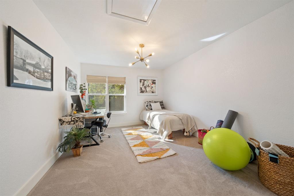 7496 East Northwest Highway, Unit 145 Dallas, TX 75231 - Photo 23 of 35 a bedroom with furniture and a window