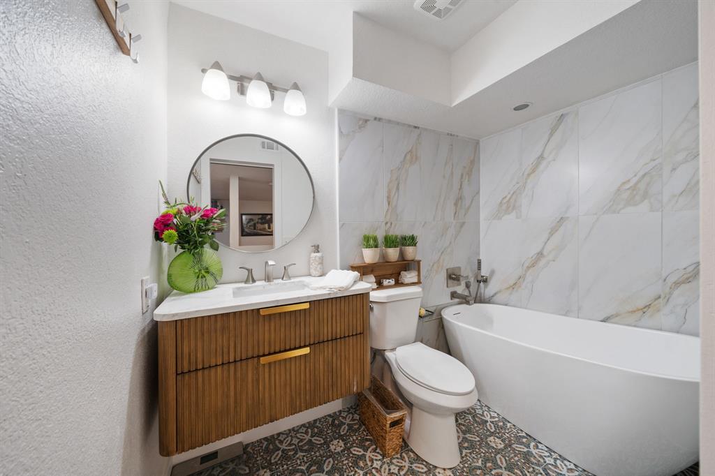 7496 East Northwest Highway, Unit 145 Dallas, TX 75231 - Photo 24 of 35 a bathroom with a sink toilet and shower