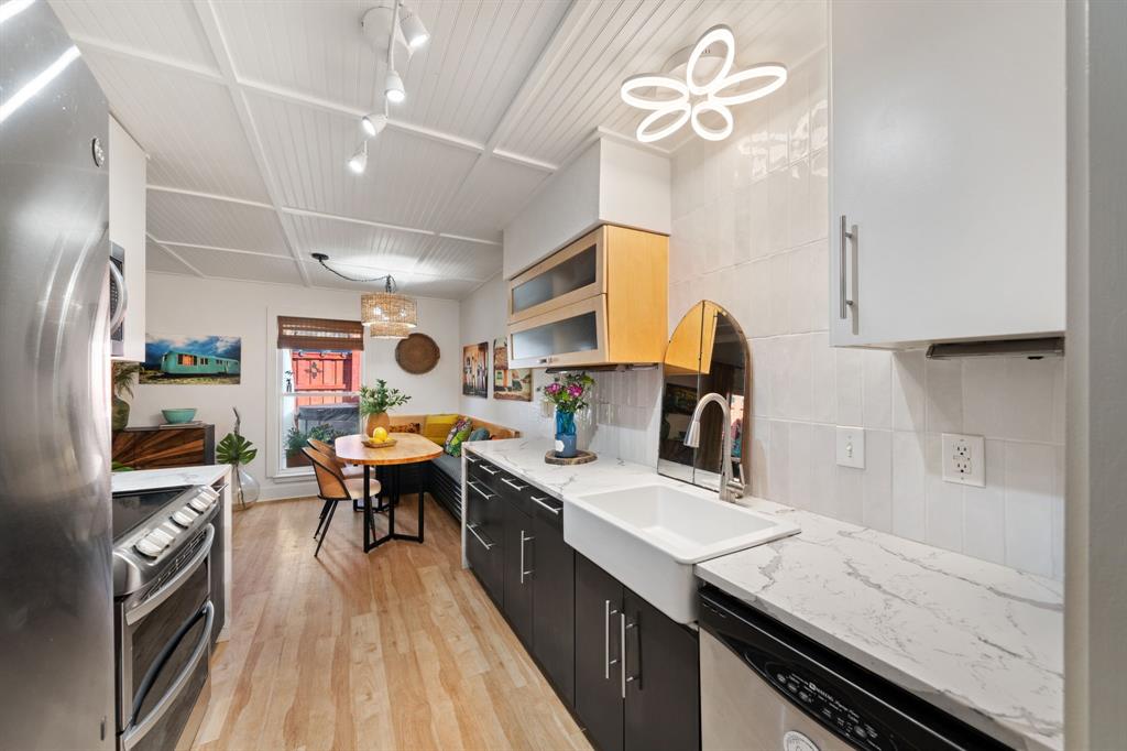 7496 East Northwest Highway, Unit 145 Dallas, TX 75231 - Photo 3 of 35 a kitchen with a sink appliances and cabinets