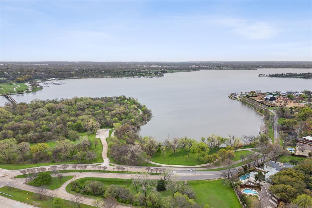 7496 East Northwest Highway, Unit 145 Dallas, TX 75231 - Photo 35 of 35 a view of a lake with houses in the back