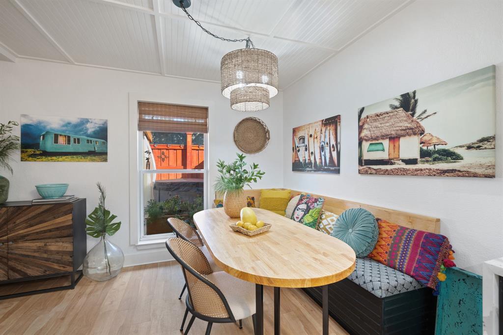 7496 East Northwest Highway, Unit 145 Dallas, TX 75231 - Photo 5 of 35 a view of a dining room with furniture and wooden floor