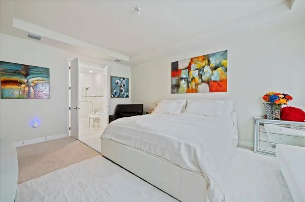 a bedroom with a bed dresser and window