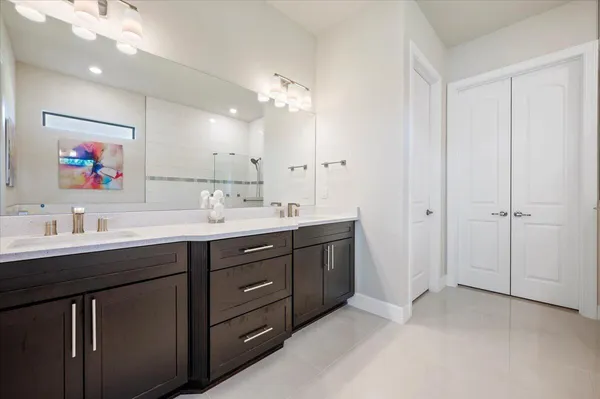 a bathroom with a double vanity sink and a mirror