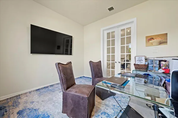 a work room with furniture and a flat screen tv