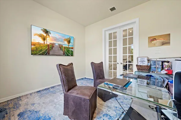a work room with furniture and a flat screen tv