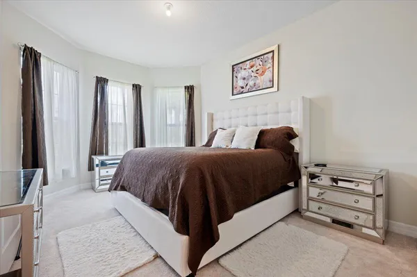a spacious bedroom with a bed and a cabinets
