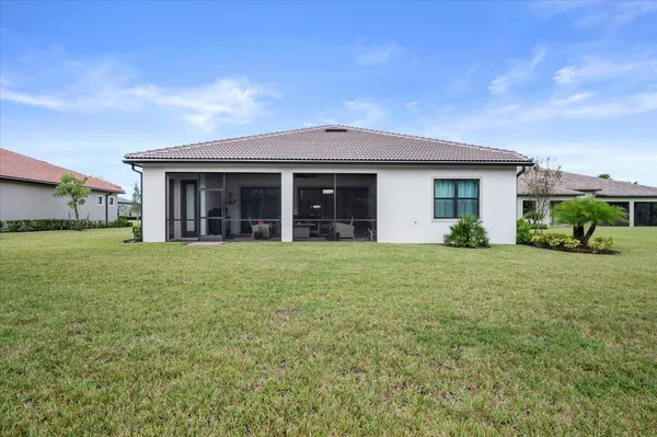 a view of a house with backyard and porch