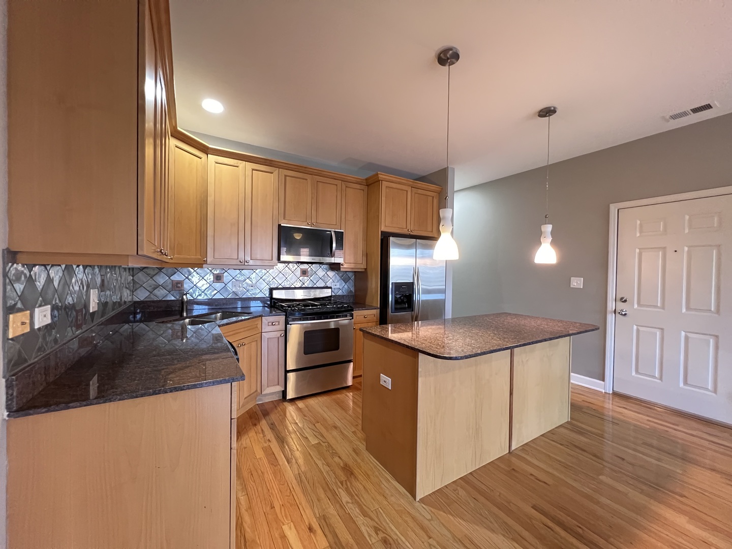 1911 South State Street, Unit 3 Chicago, IL 60616 - Photo 11 of 26 a kitchen with stainless steel appliances granite countertop a sink stove and refrigerator