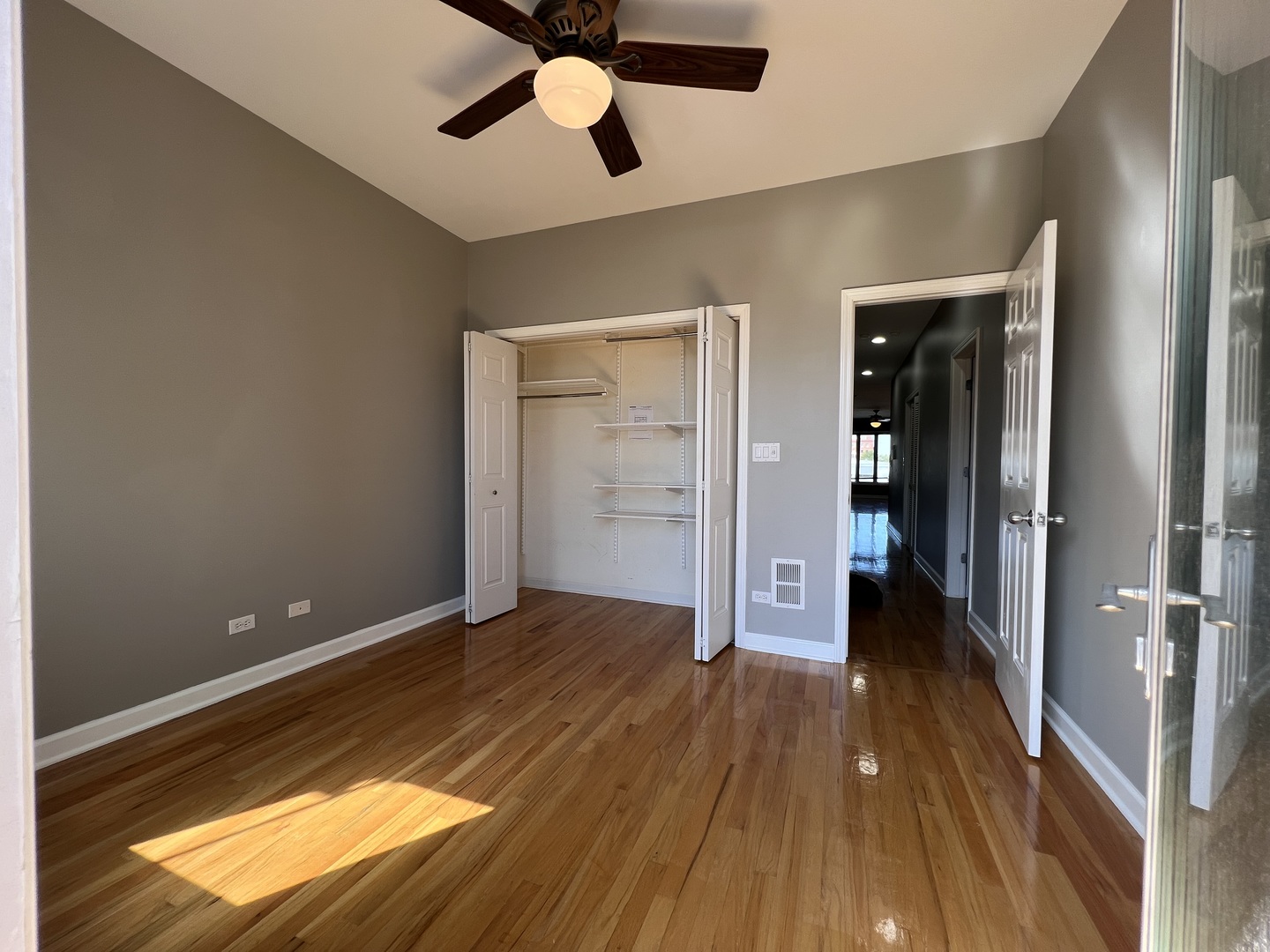 1911 South State Street, Unit 3 Chicago, IL 60616 - Photo 17 of 26 a view of a room with wooden floor a ceiling fan and closet area