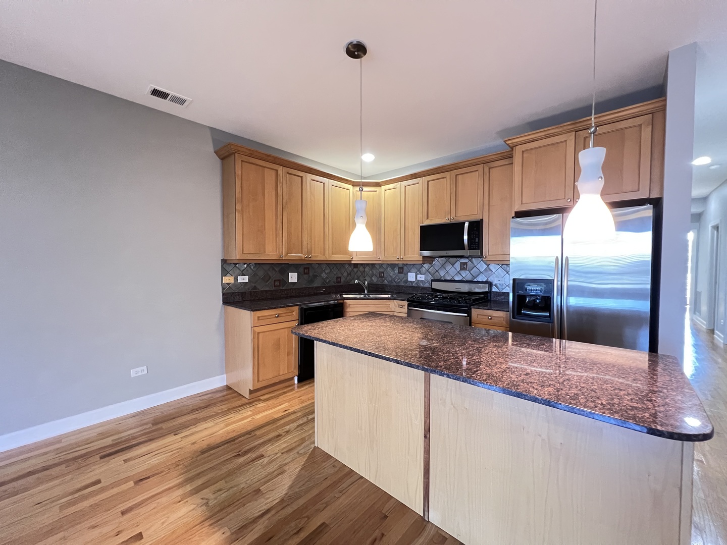 1911 South State Street, Unit 3 Chicago, IL 60616 - Photo 10 of 26 a kitchen with stainless steel appliances granite countertop a stove a sink and a refrigerator