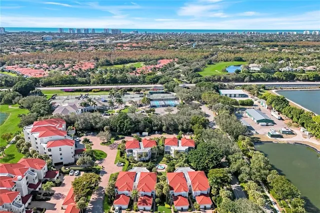 an aerial view of lake and residential houses with outdoor space