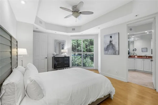 a bedroom with a large bed and a view of kitchen