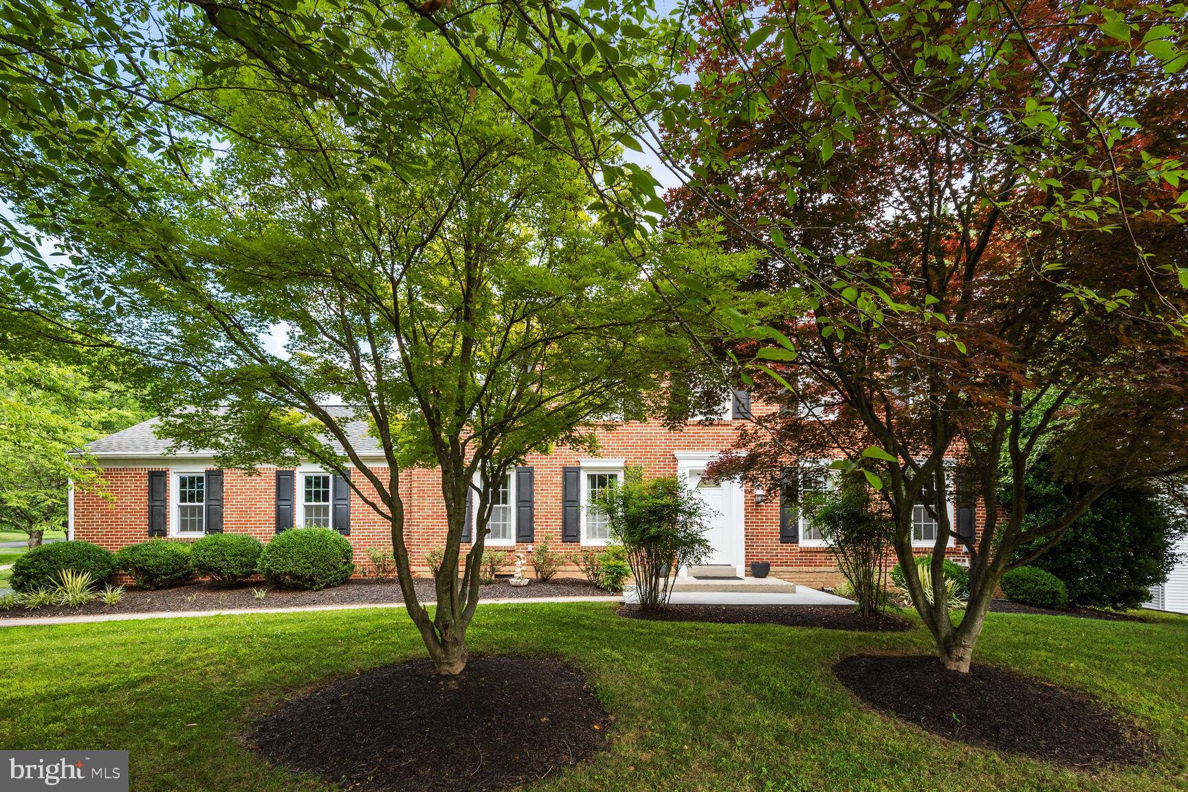 12324 Triple Crown Road North Potomac, MD 20878 - Photo 1 of 49 a front view of a house with garden
