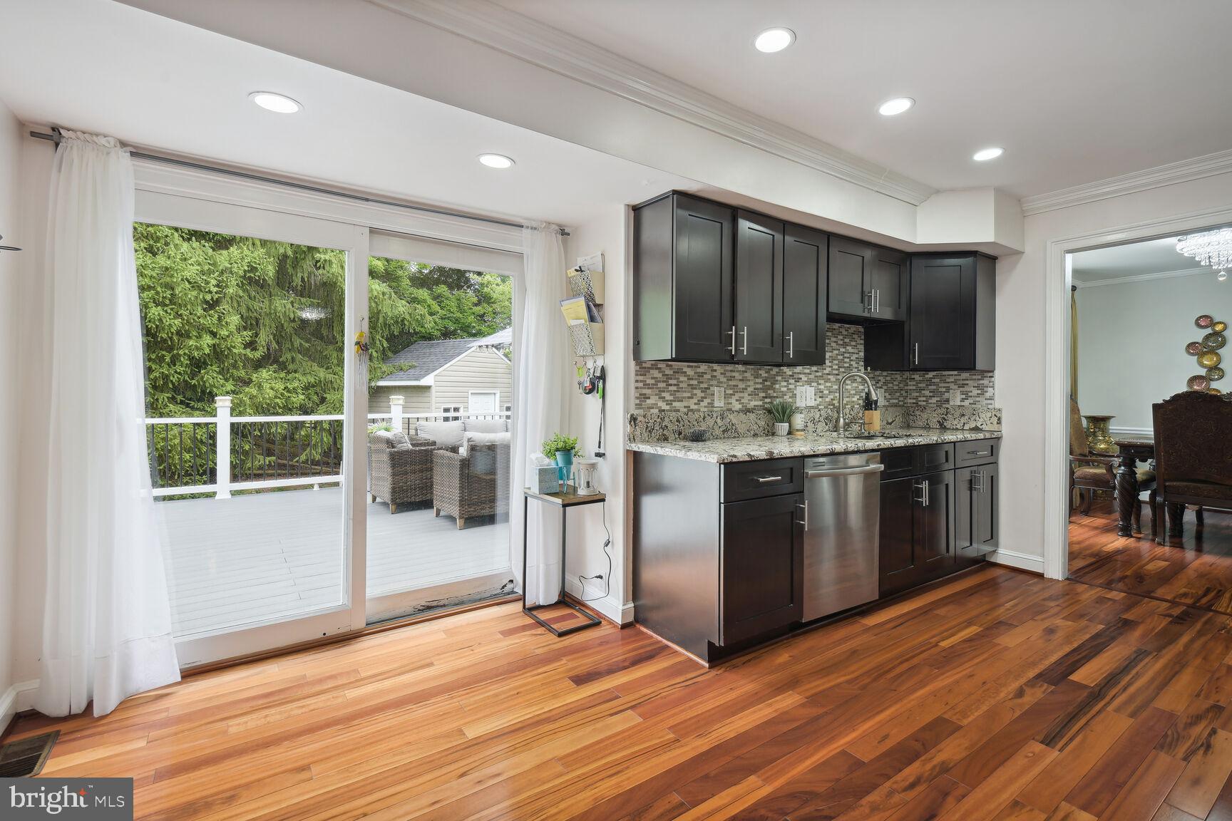 12324 Triple Crown Road North Potomac, MD 20878 - Photo 18 of 49 a kitchen with stainless steel appliances granite countertop a stove a sink and a refrigerator