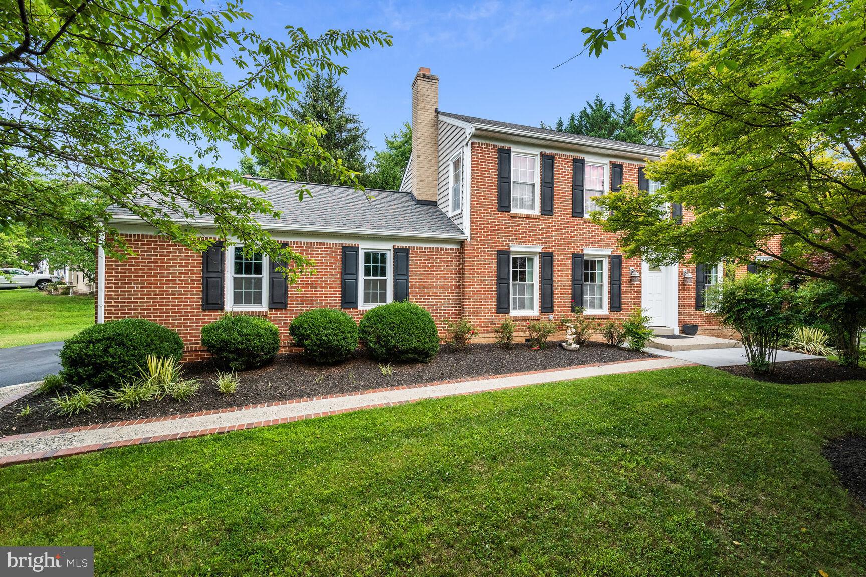 12324 Triple Crown Road North Potomac, MD 20878 - Photo 2 of 49 a front view of a house with a yard