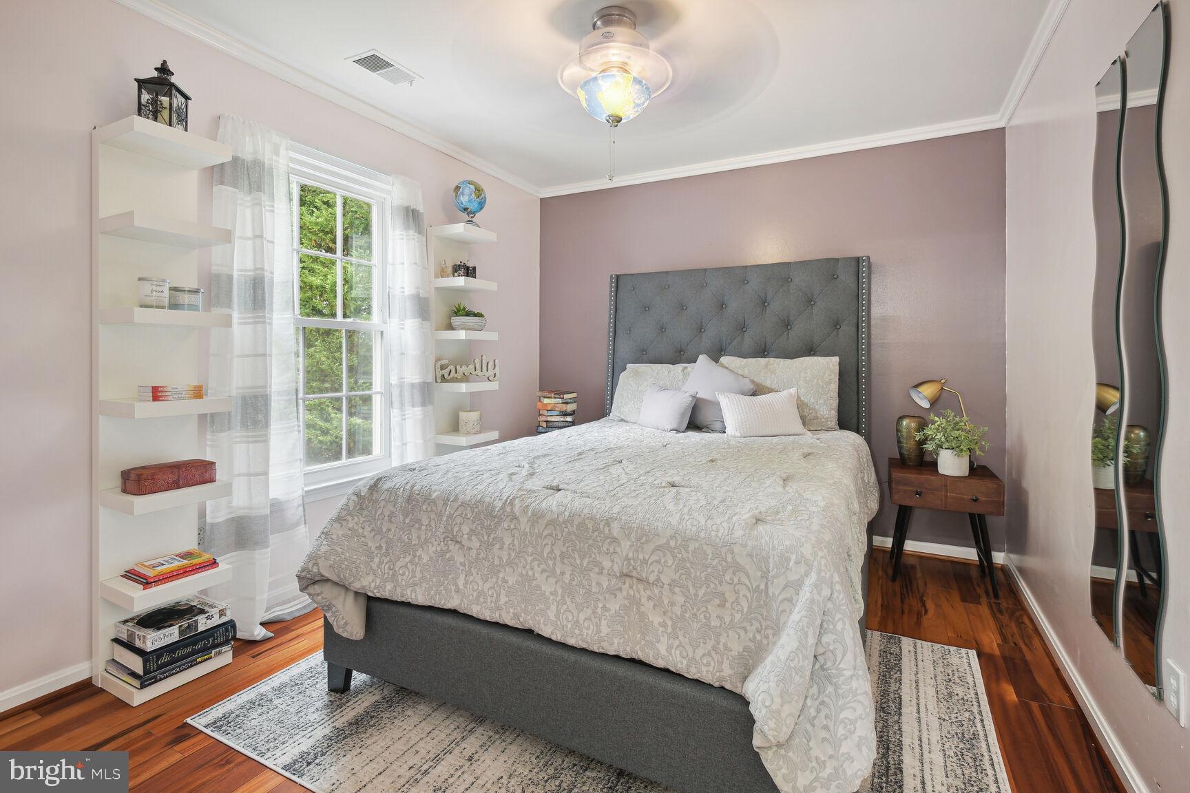 12324 Triple Crown Road North Potomac, MD 20878 - Photo 27 of 49 a bed sitting in a bedroom next to a window