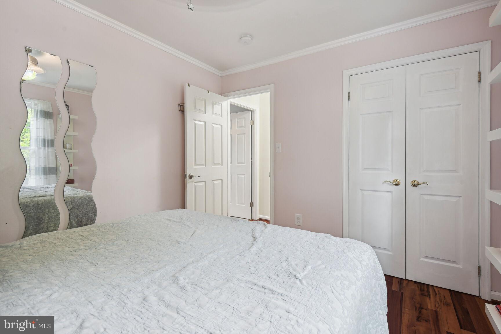 12324 Triple Crown Road North Potomac, MD 20878 - Photo 28 of 49 a bedroom with a bed and a mirror