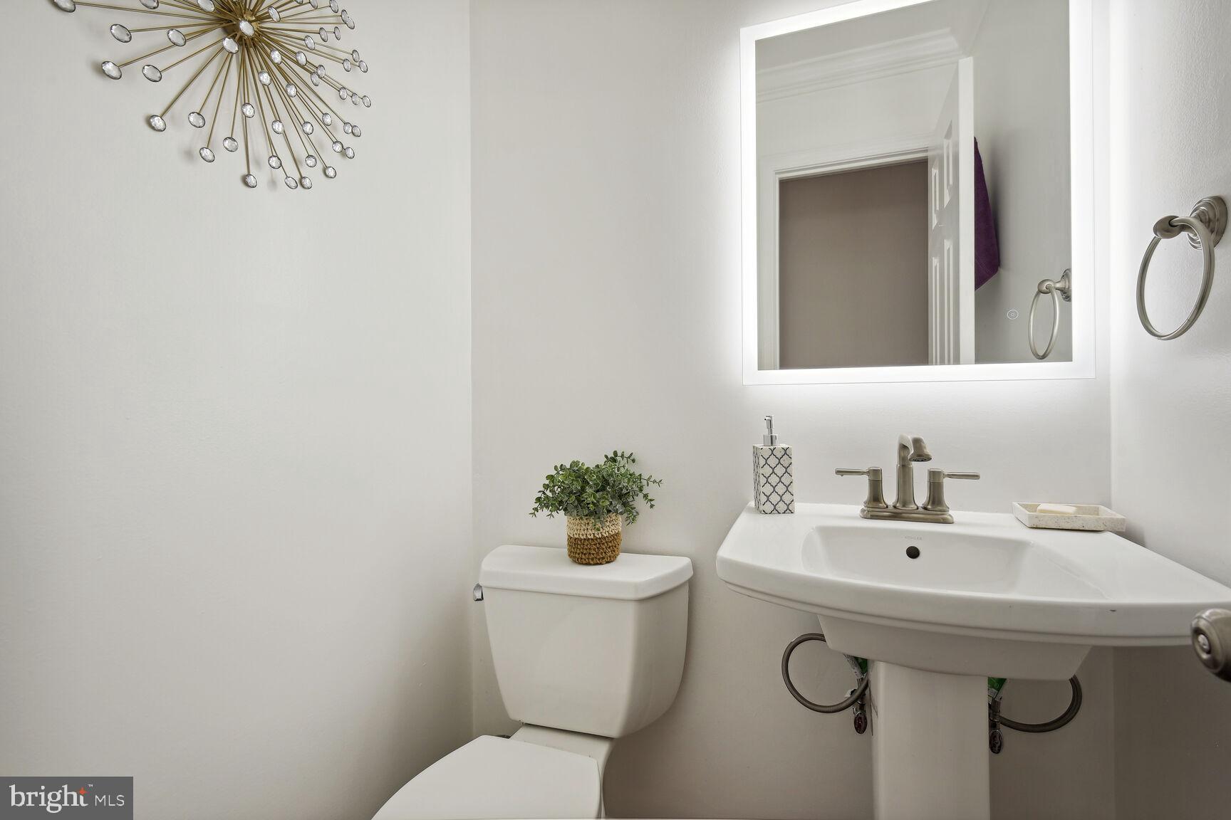 12324 Triple Crown Road North Potomac, MD 20878 - Photo 31 of 49 a bathroom with a sink mirror and toilet