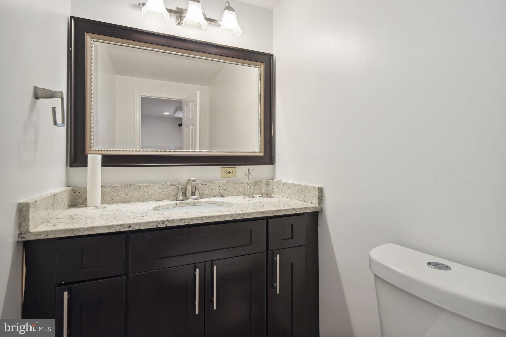 12324 Triple Crown Road North Potomac, MD 20878 - Photo 32 of 49 a bathroom with a toilet sink and mirror