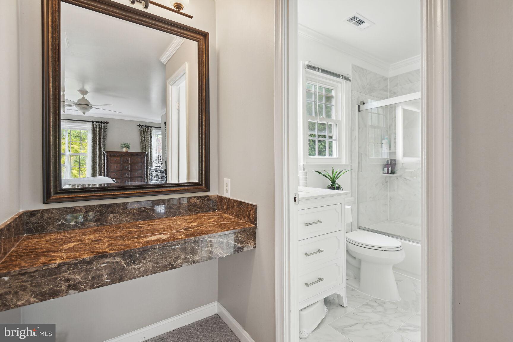 12324 Triple Crown Road North Potomac, MD 20878 - Photo 33 of 49 a bathroom with a granite countertop sink and a mirror