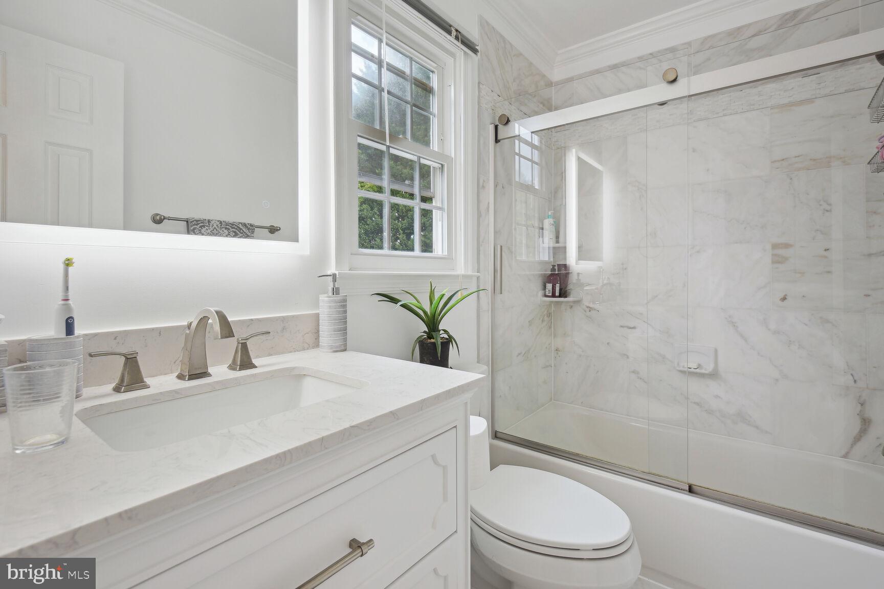 12324 Triple Crown Road North Potomac, MD 20878 - Photo 34 of 49 a bathroom with a sink a toilet and shower