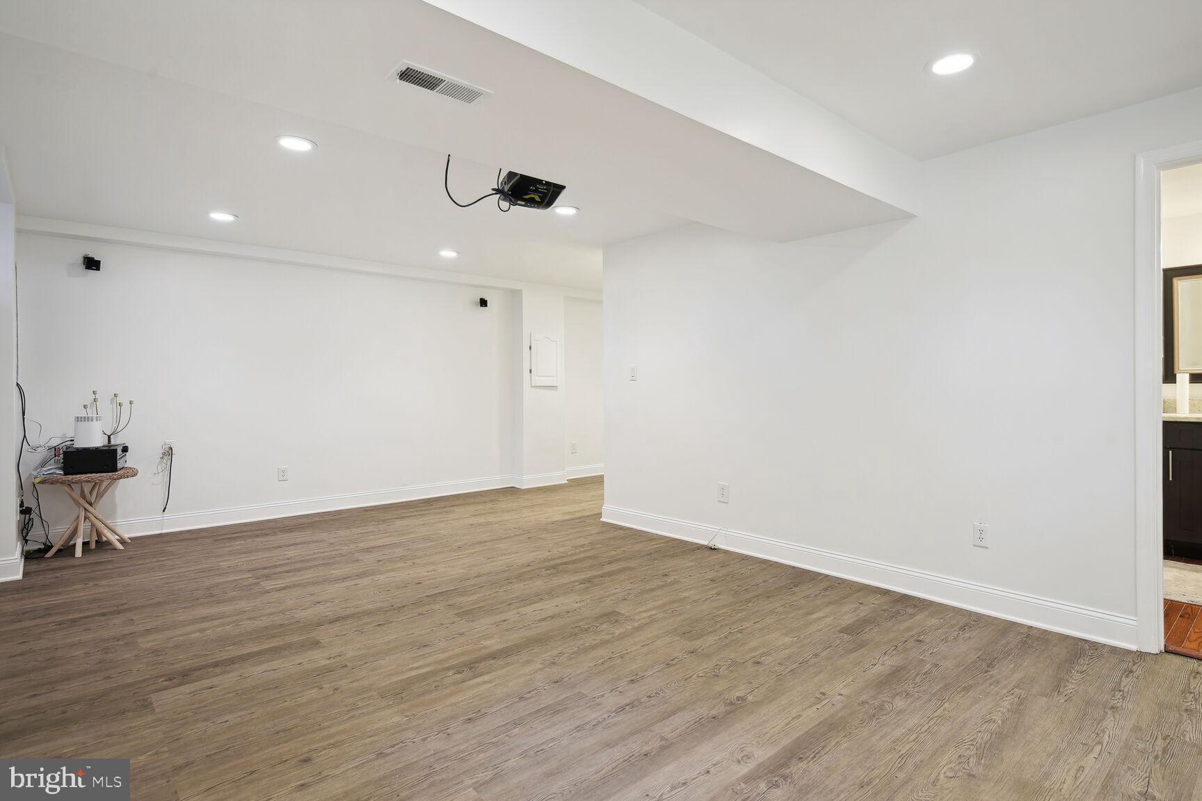 12324 Triple Crown Road North Potomac, MD 20878 - Photo 40 of 49 an empty room with wooden floor and windows