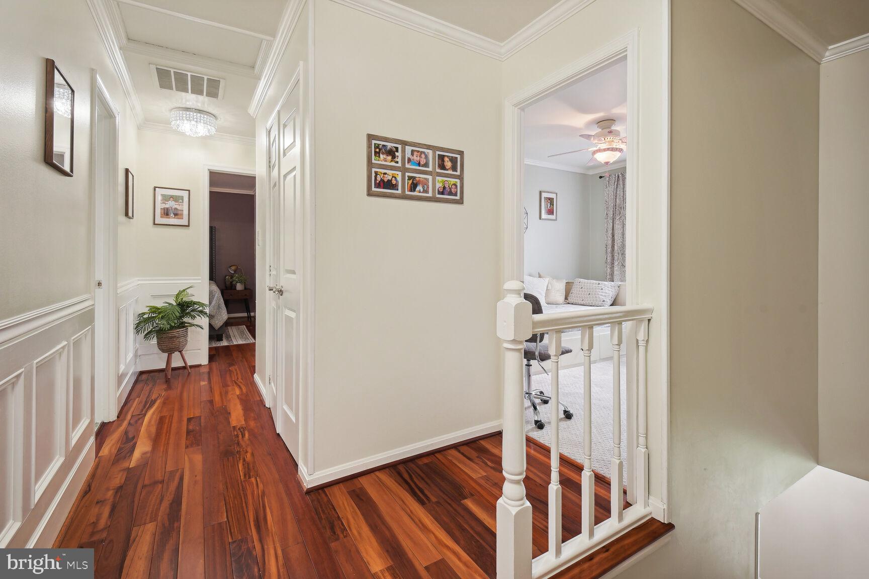 12324 Triple Crown Road North Potomac, MD 20878 - Photo 6 of 49 a view of a hallway with wooden floor and staircase