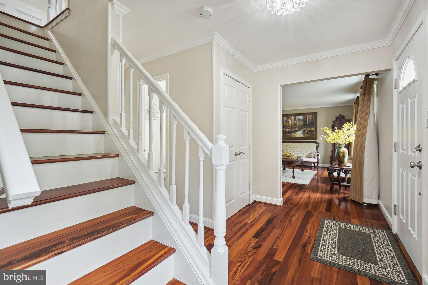 12324 Triple Crown Road North Potomac, MD 20878 - Photo 7 of 49 a view of a hallway with wooden floor and stairs