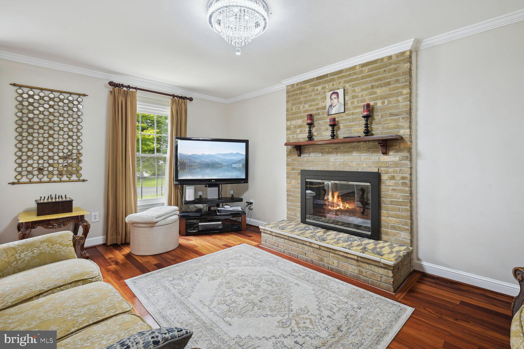 12324 Triple Crown Road North Potomac, MD 20878 - Photo 8 of 49 a living room with furniture and a fireplace