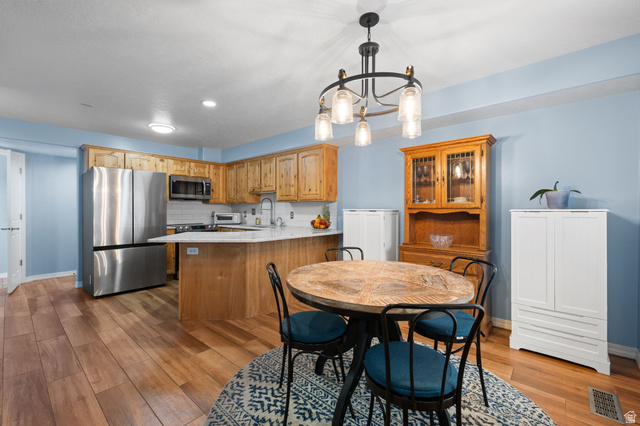 1625 Pages Pl Drive Bountiful, UT 84010 - Photo 10 of 31 Dining area with ceramic wood tile flooring and upgraded lighting