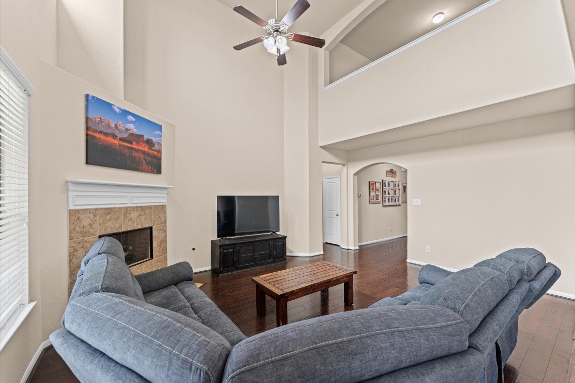 22534 Rustic Valley Court Porter, TX 77365 - Photo 13 of 27 a living room with furniture a flat screen tv and a fireplace