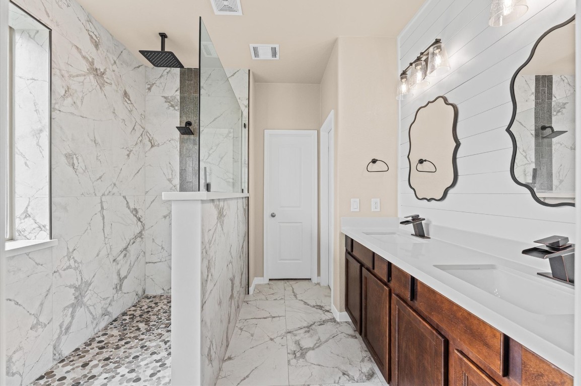 22534 Rustic Valley Court Porter, TX 77365 - Photo 15 of 27 a spacious bathroom with a double vanity sink mirror and shower