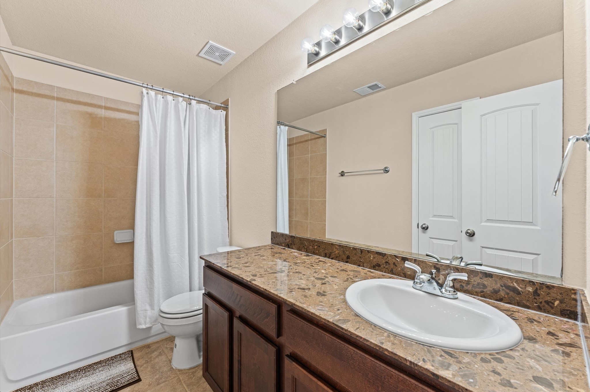 22534 Rustic Valley Court Porter, TX 77365 - Photo 17 of 27 a bathroom with a granite countertop sink toilet and shower
