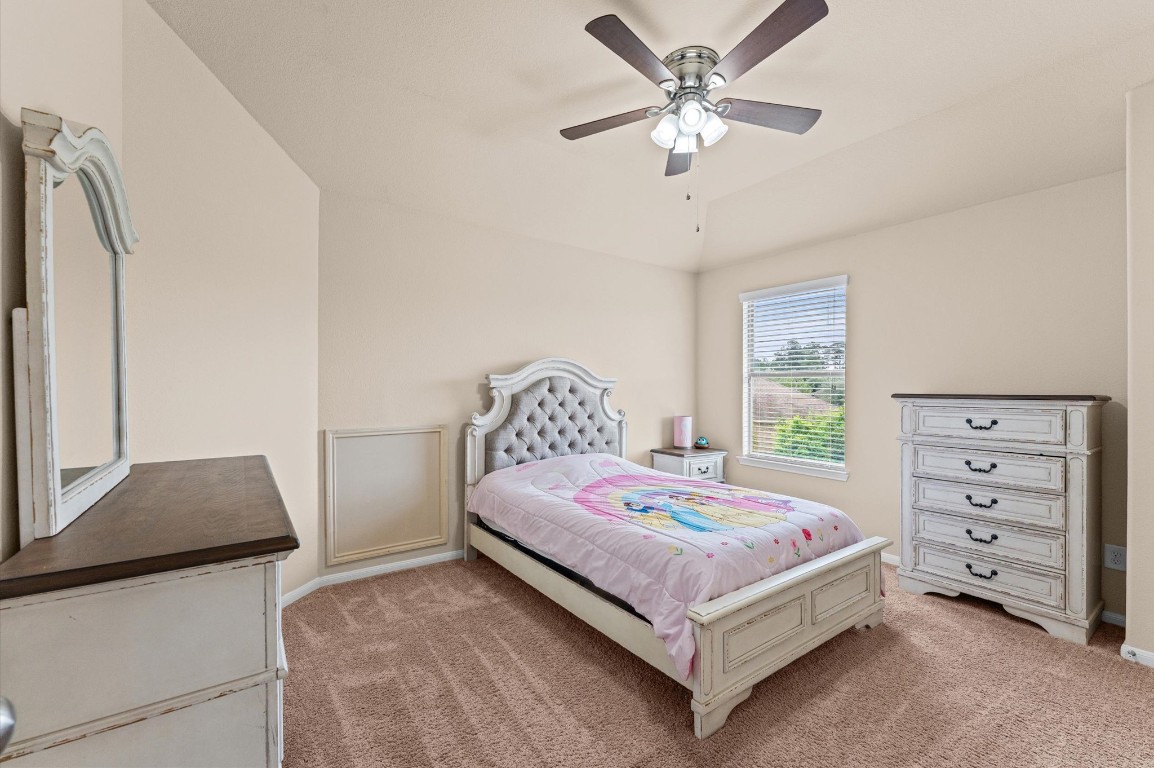 22534 Rustic Valley Court Porter, TX 77365 - Photo 18 of 27 a bedroom with a bed and a flat tv screen on dresser