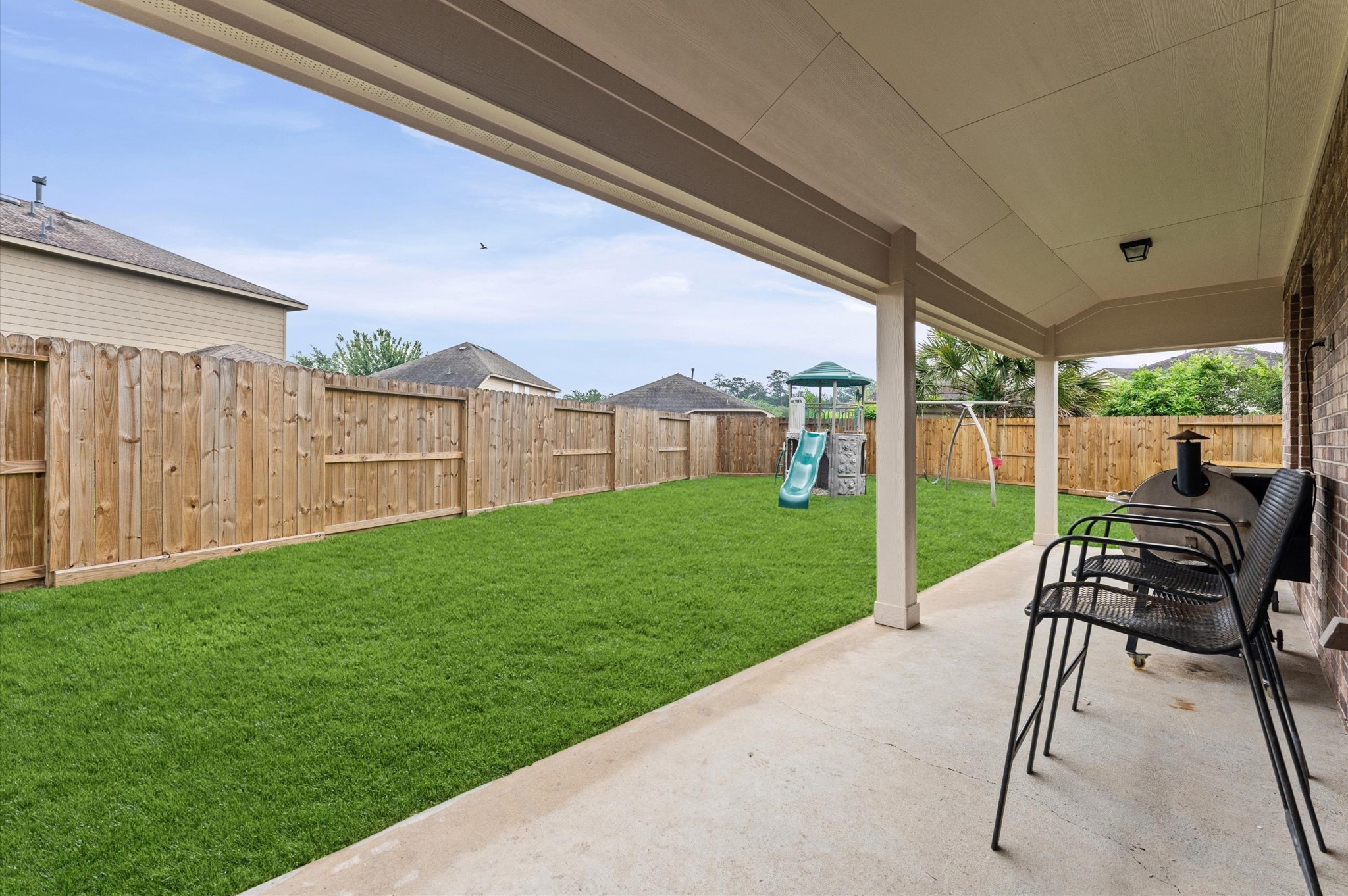 22534 Rustic Valley Court Porter, TX 77365 - Photo 21 of 27 a view of a patio with a table chairs and a yard