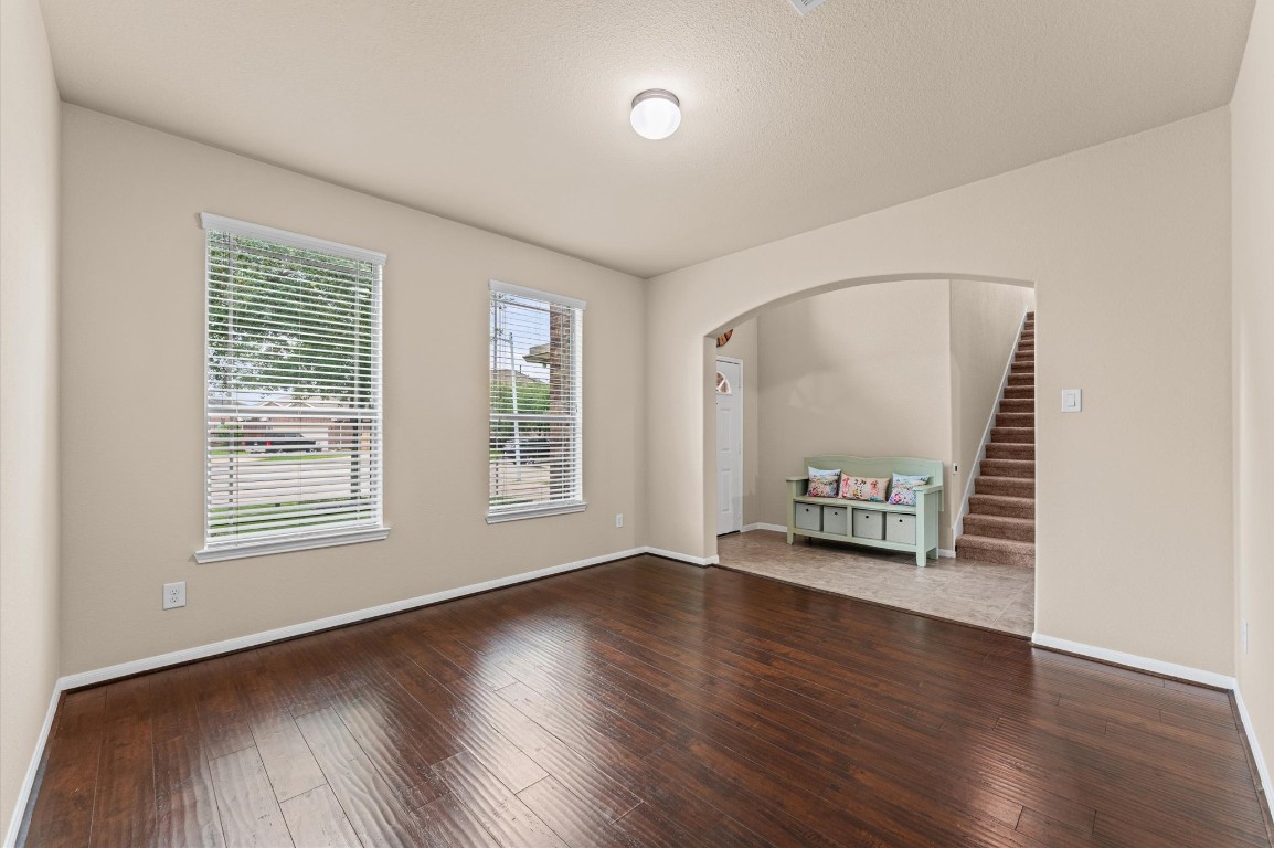22534 Rustic Valley Court Porter, TX 77365 - Photo 4 of 27 an empty room with wooden floor and windows
