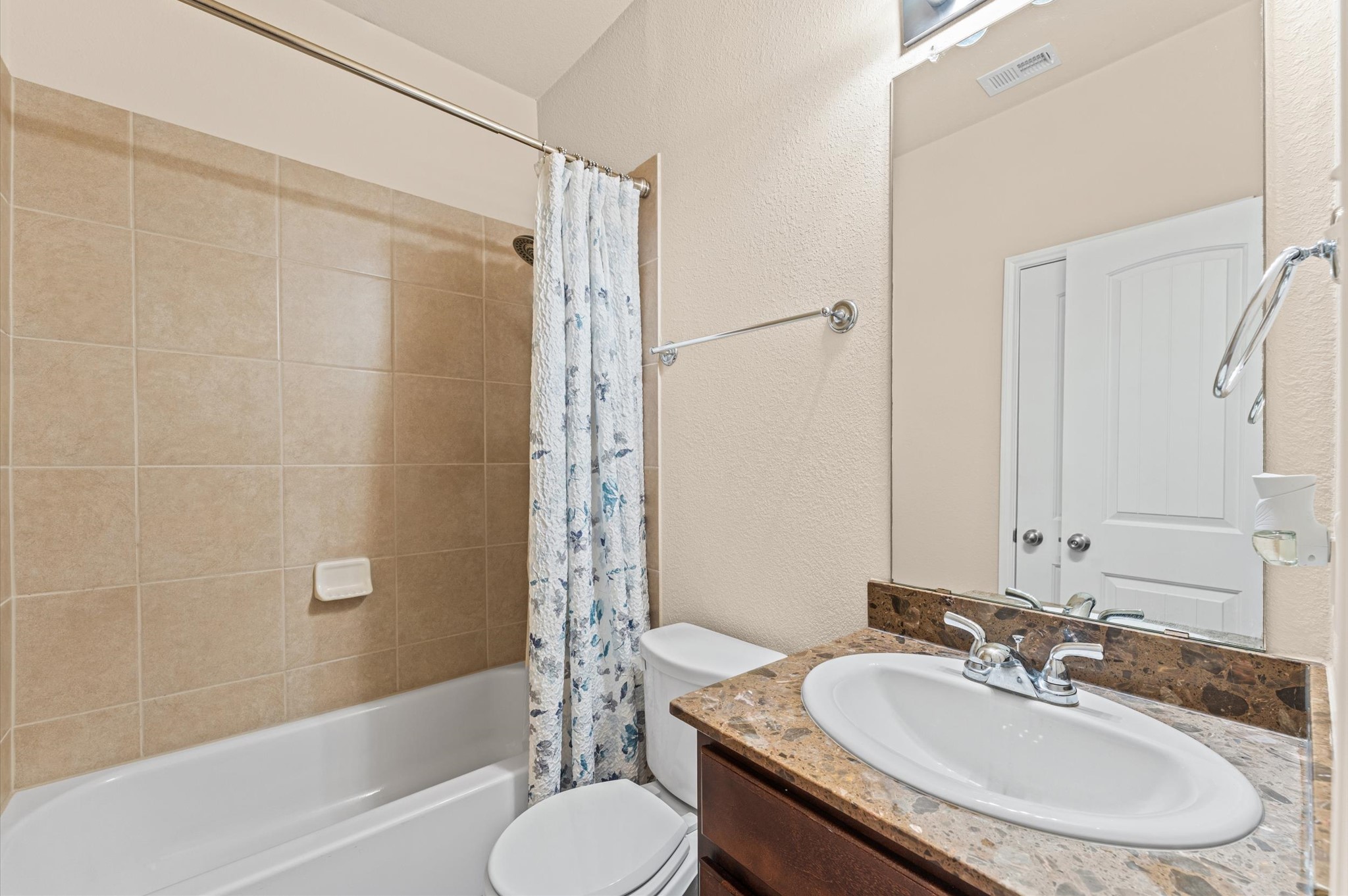 22534 Rustic Valley Court Porter, TX 77365 - Photo 5 of 27 a bathroom with a granite countertop sink toilet and shower
