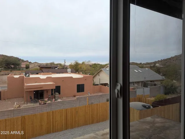 a view of a balcony with furniture and a floor to ceiling window