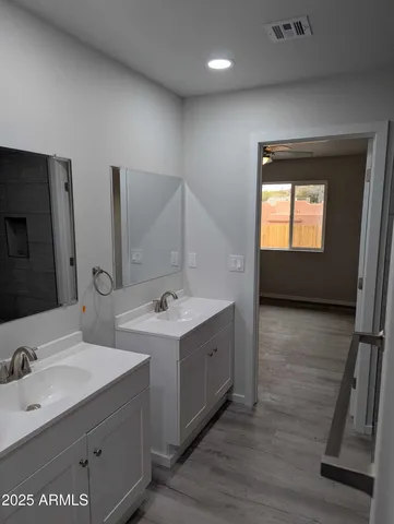 a view of bathroom with dual sinks