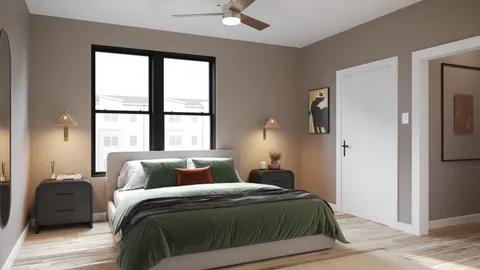 a bedroom with a bed and a window