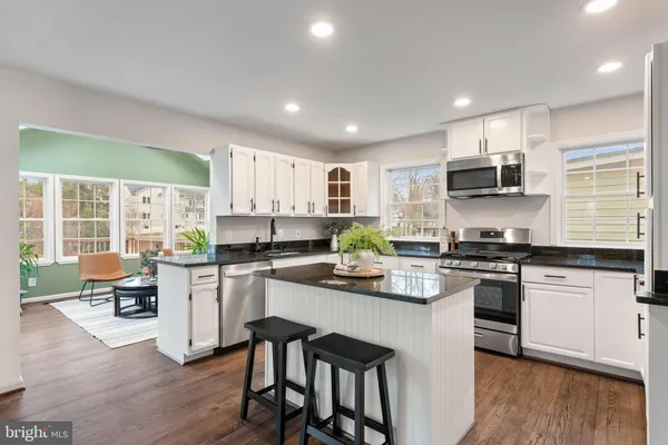 a kitchen with a sink cabinets and wooden floor