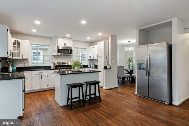 a living room with furniture and a ceiling fan