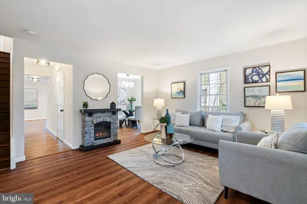 a living room with fireplace furniture and a wooden floor