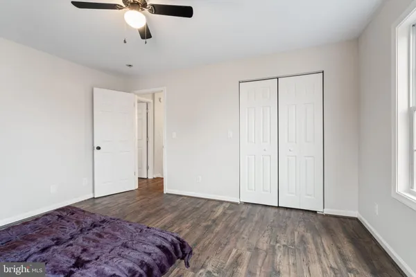a bathroom with a toilet sink vanity and mirror